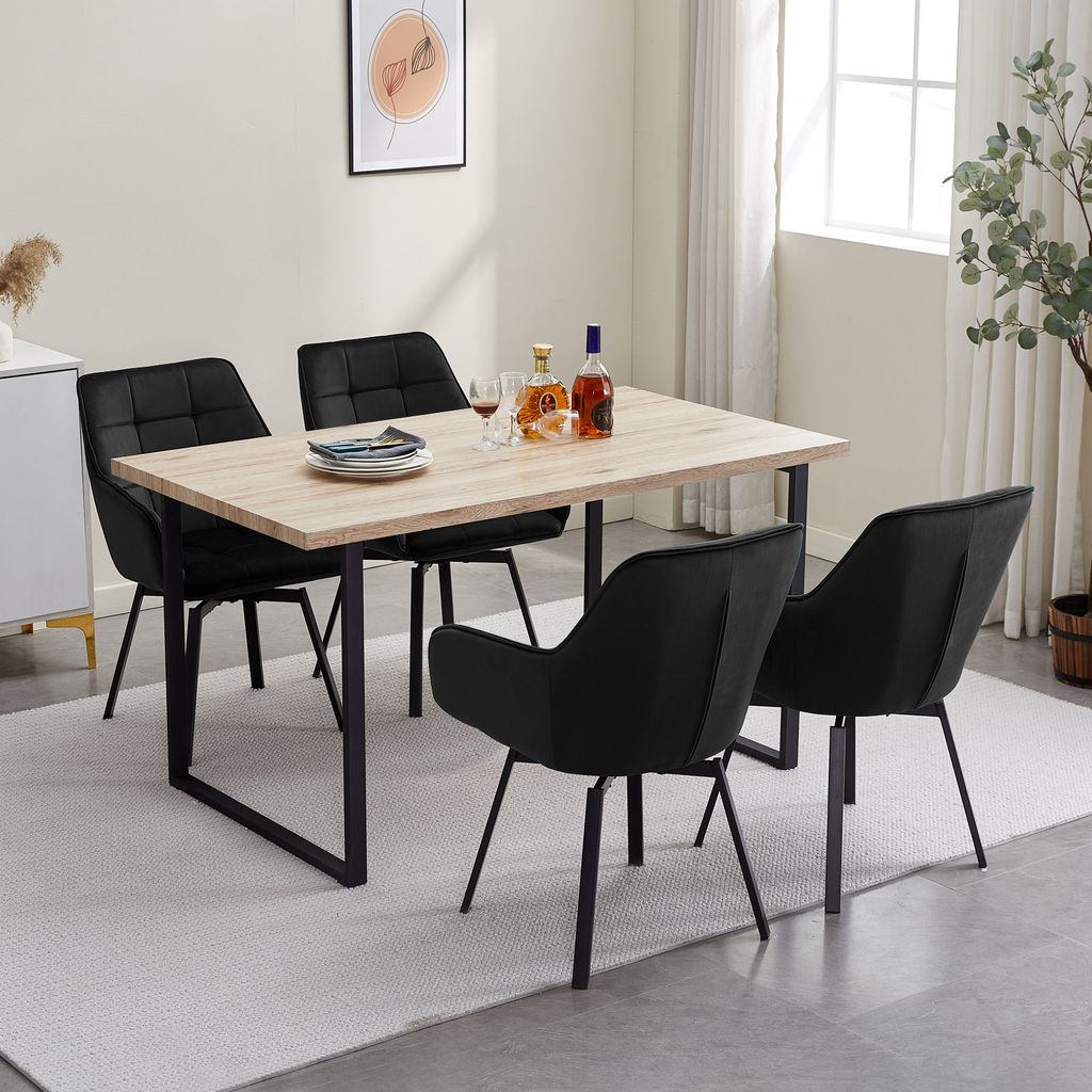 A dining set with four black chairs and a light wood table.