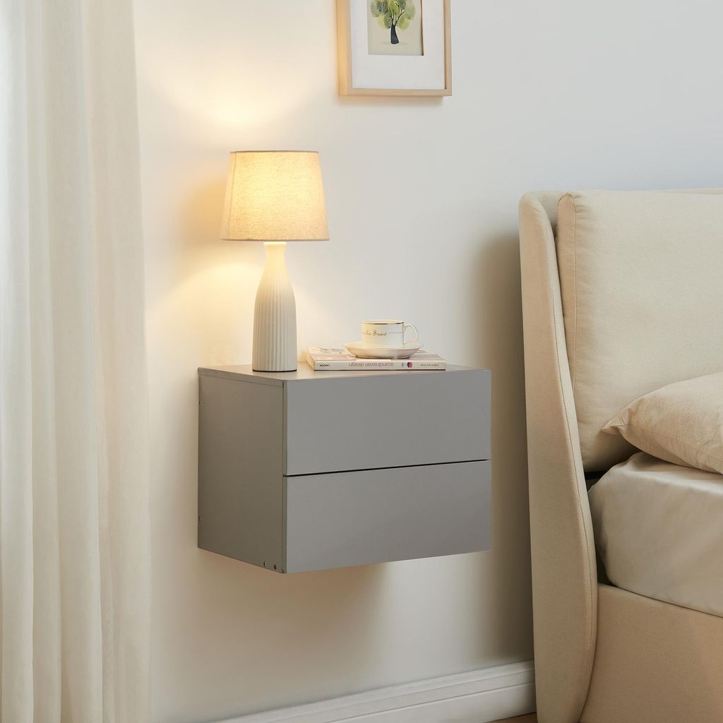 A modern bedroom scene with a wall-mounted nightstand next to a bed.
