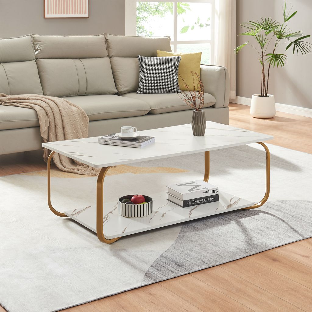 A living room scene with a couch, coffee table, and rug.