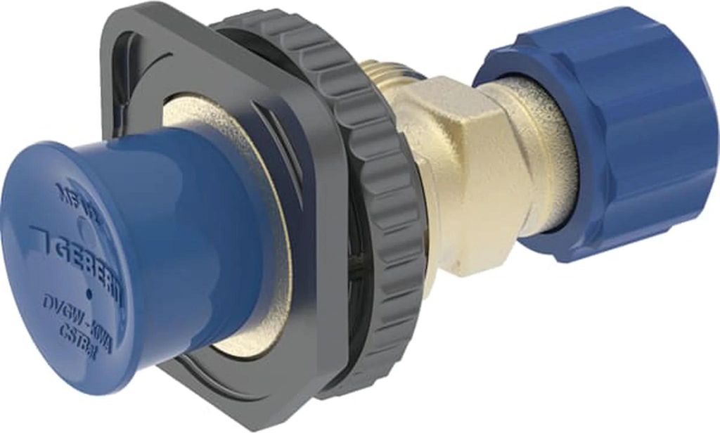 A plumbing fitting with a blue cap and a blue nut, connected to a brass valve, mounted on a gray flange.
