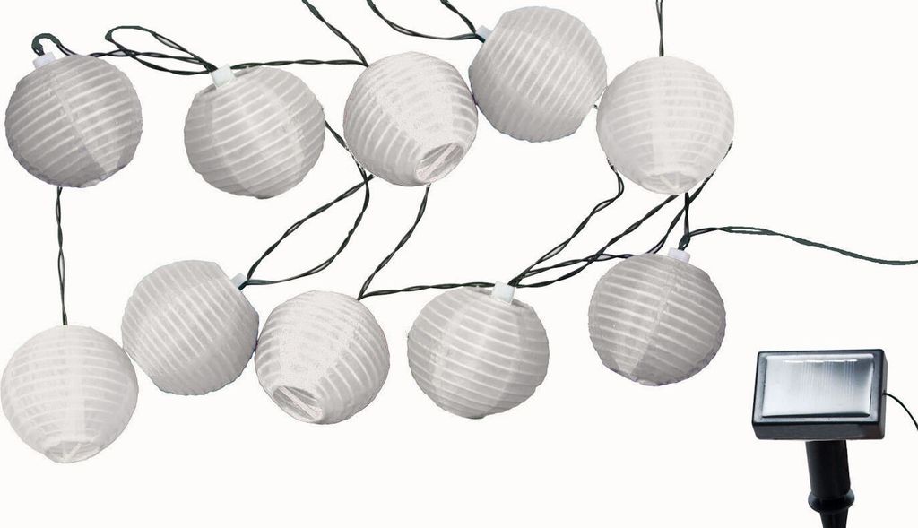 A string of white paper lanterns with a solar panel attached.