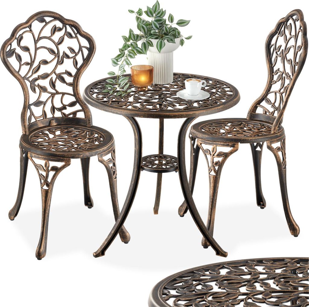 A bistro set with two chairs and a table, decorated with a leaf motif.