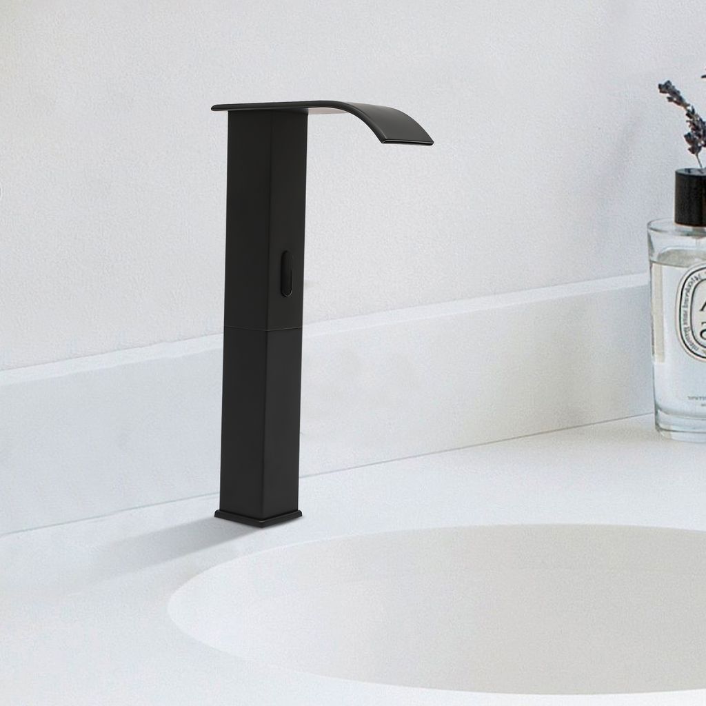 A black waterfall faucet is shown installed on a white countertop next to a sink. A bottle of perfume with lavender sprigs is visible in the background.