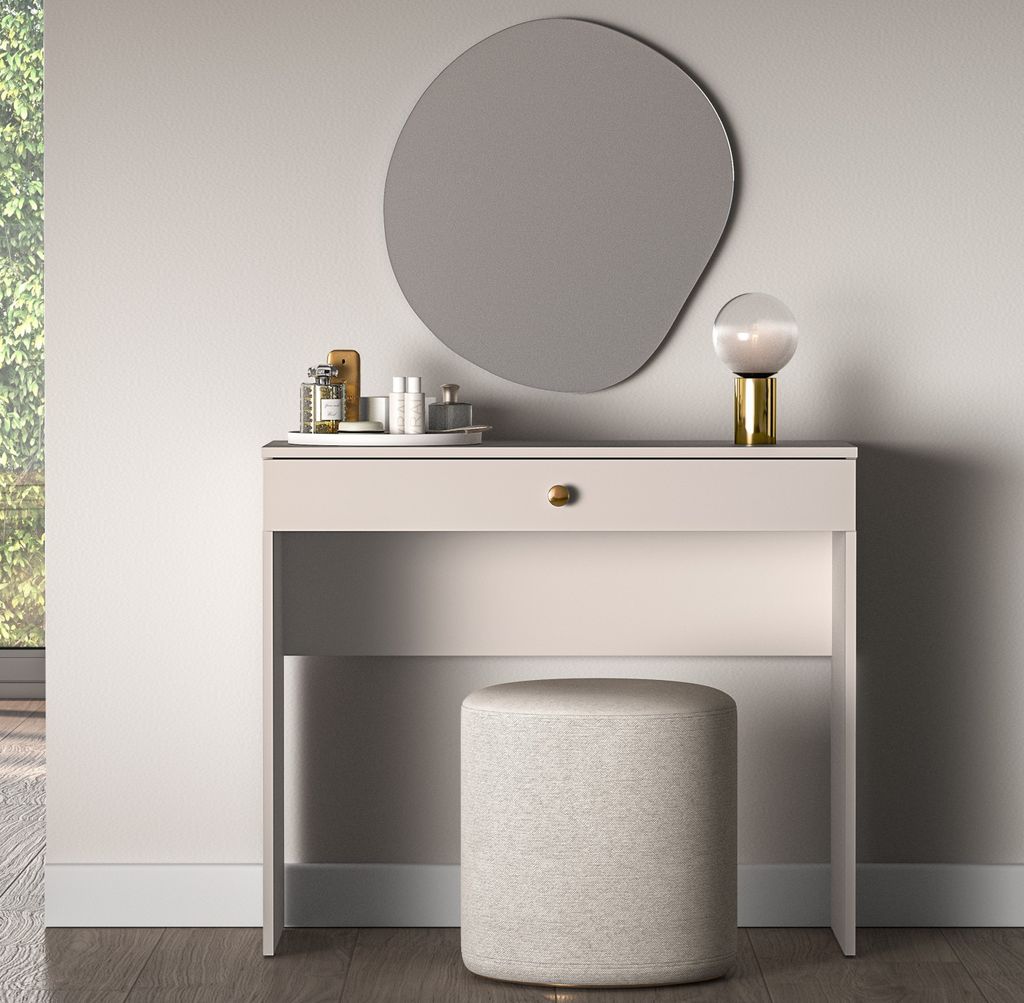 A vanity table with a mirror and stool in a room.