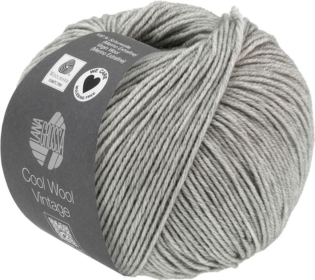 A ball of gray yarn with a label wrapped around it.