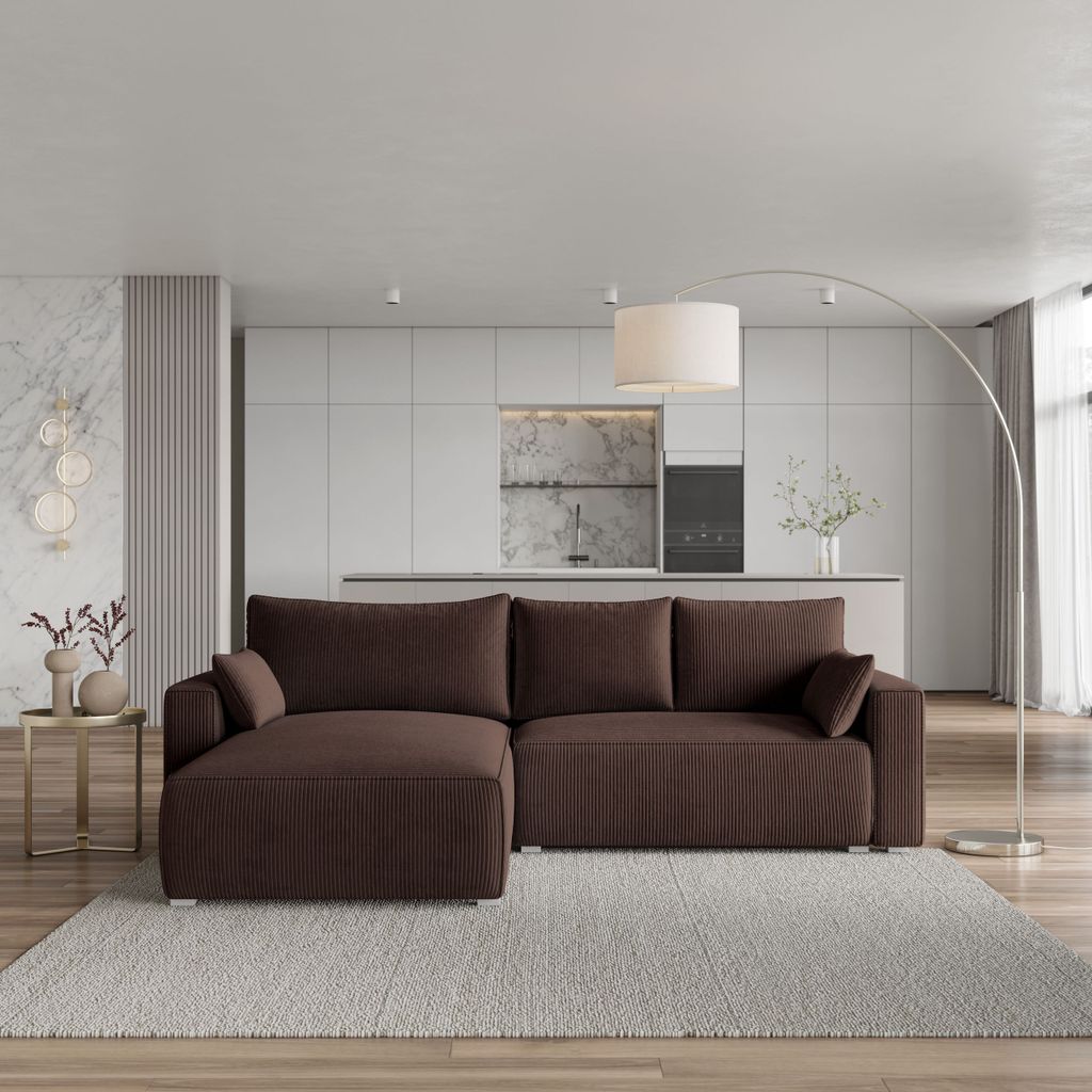 A modern living room with a sectional sofa in front of a kitchen area.