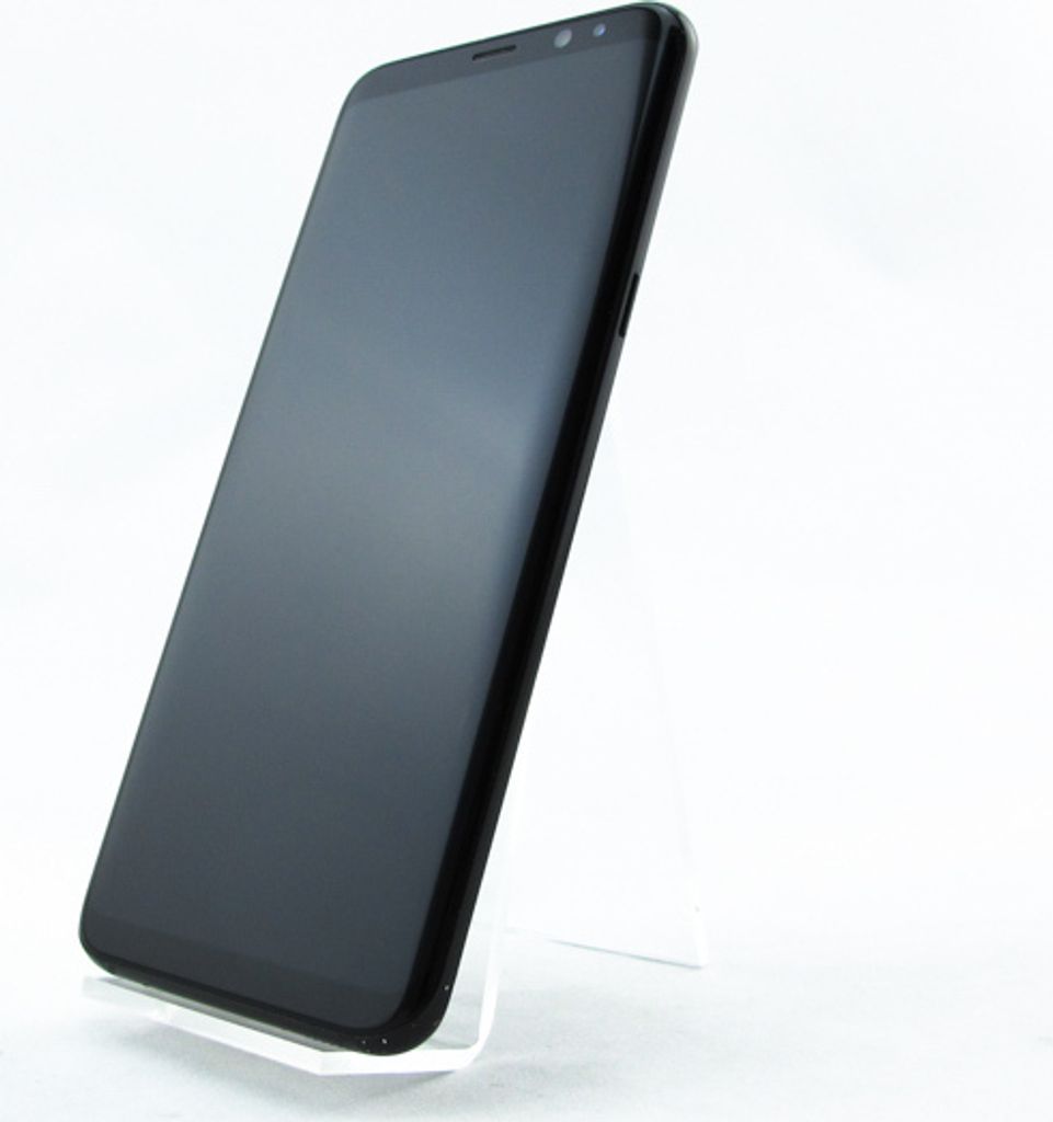 A black Samsung Galaxy S8+ smartphone is displayed on a clear stand against a white background.