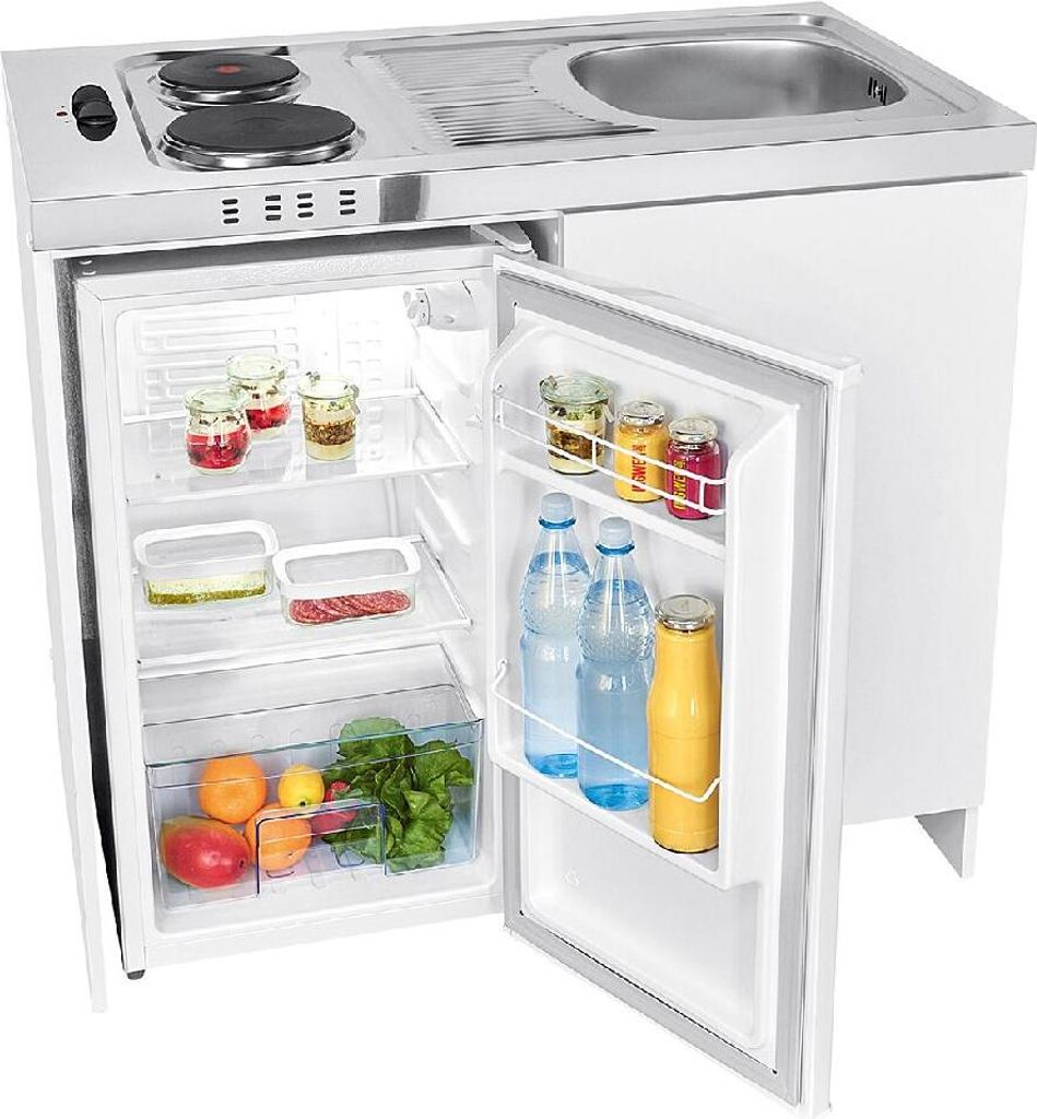 A compact kitchen unit with a refrigerator, sink, and stovetop, with the refrigerator door open showing food and drinks inside.