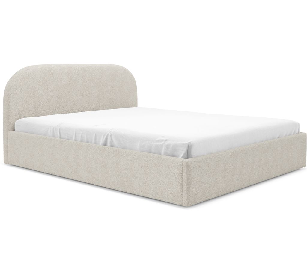 A beige upholstered bed with a white fitted sheet, shown from a side angle against a white background.