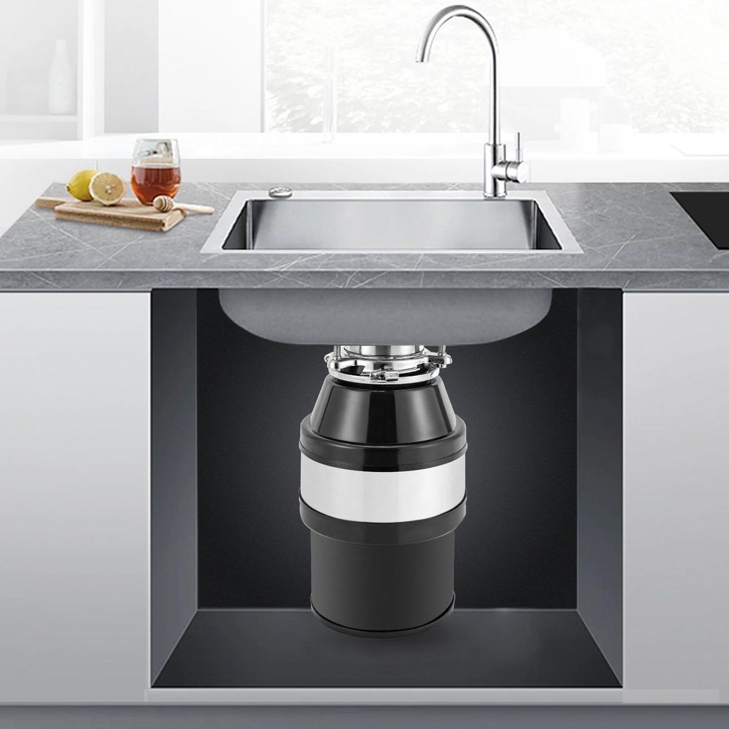 A cross-section view of a kitchen sink with a garbage disposal unit installed underneath.