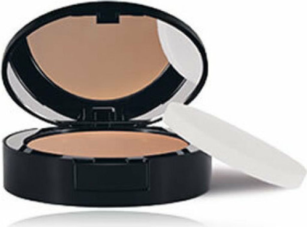 A compact powder makeup product with its applicator is shown against a white background.
