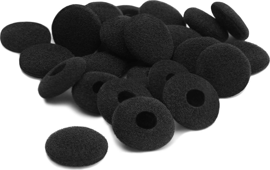 A pile of black foam earphone covers on a white background.