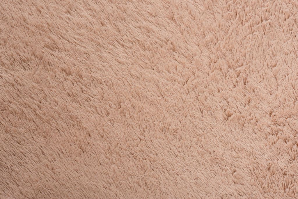 A close-up view of a soft, textured rug.