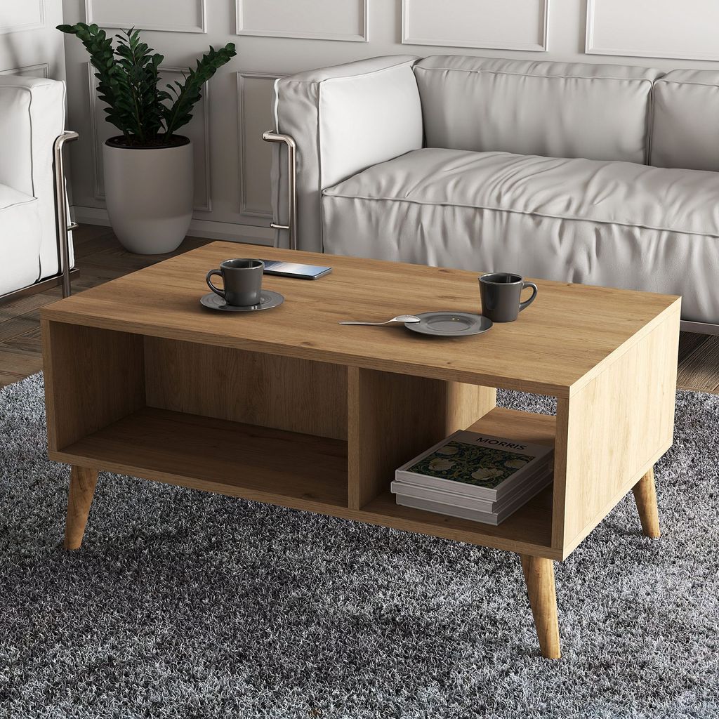 A modern living room scene with a coffee table, sofa, and armchair.