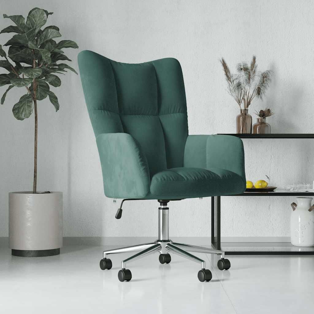 A dark green velvet armchair with a silver base and wheels, placed in a room with a potted plant and a shelf with decorative items.
