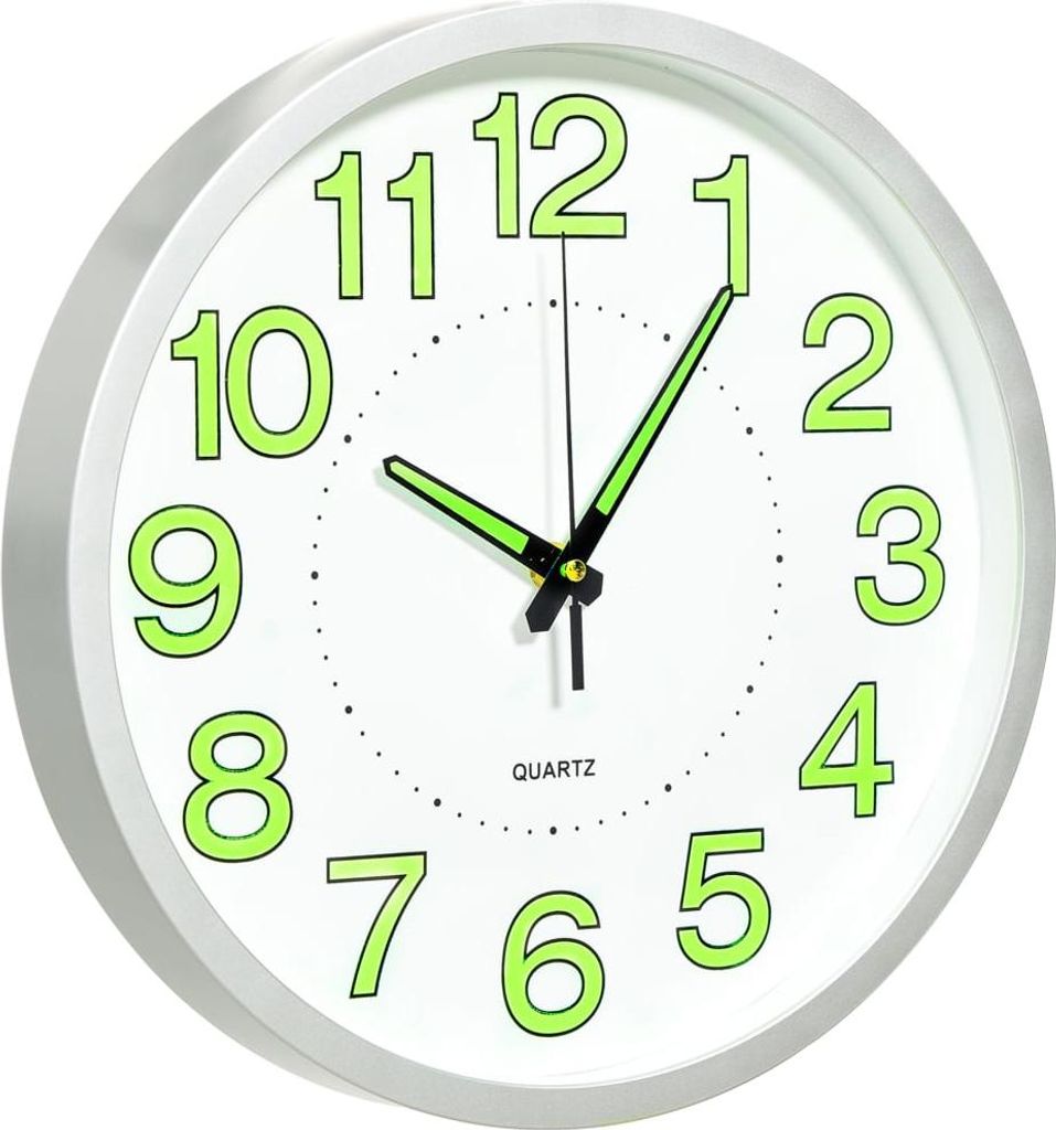 A white wall clock with green luminous numbers and hands.