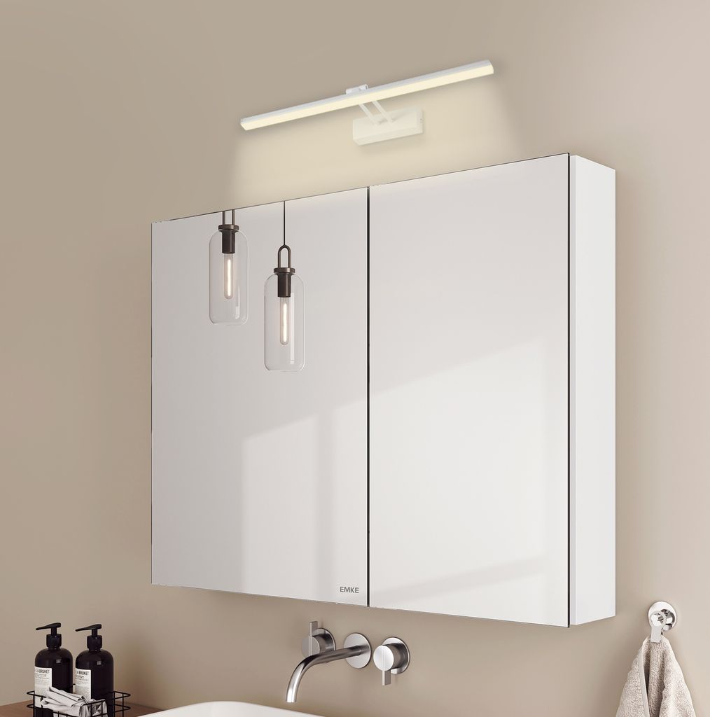 A modern bathroom vanity with a mirrored cabinet and integrated lighting.