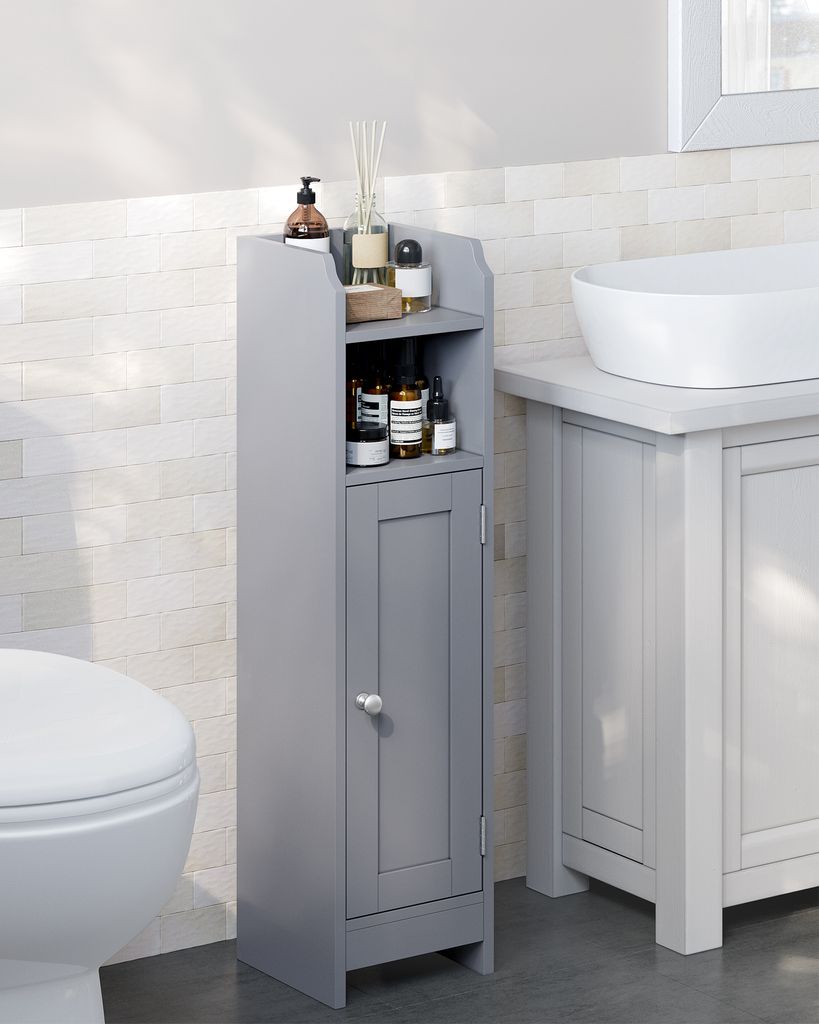 A narrow gray bathroom cabinet is shown next to a toilet and under a sink.