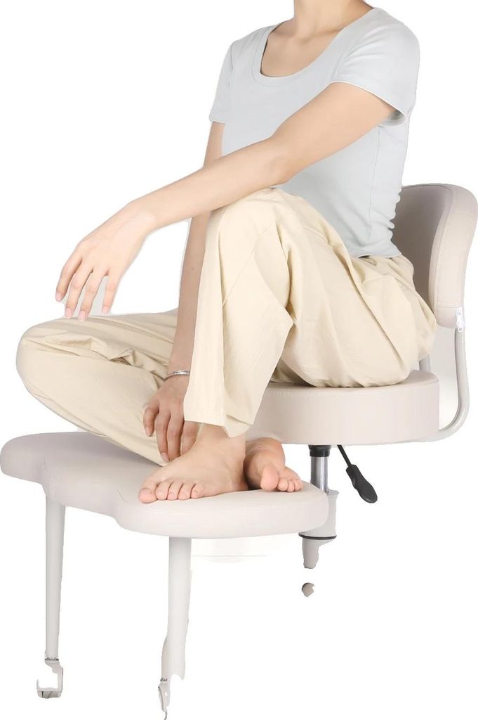 A person sitting on a chair with their legs crossed.