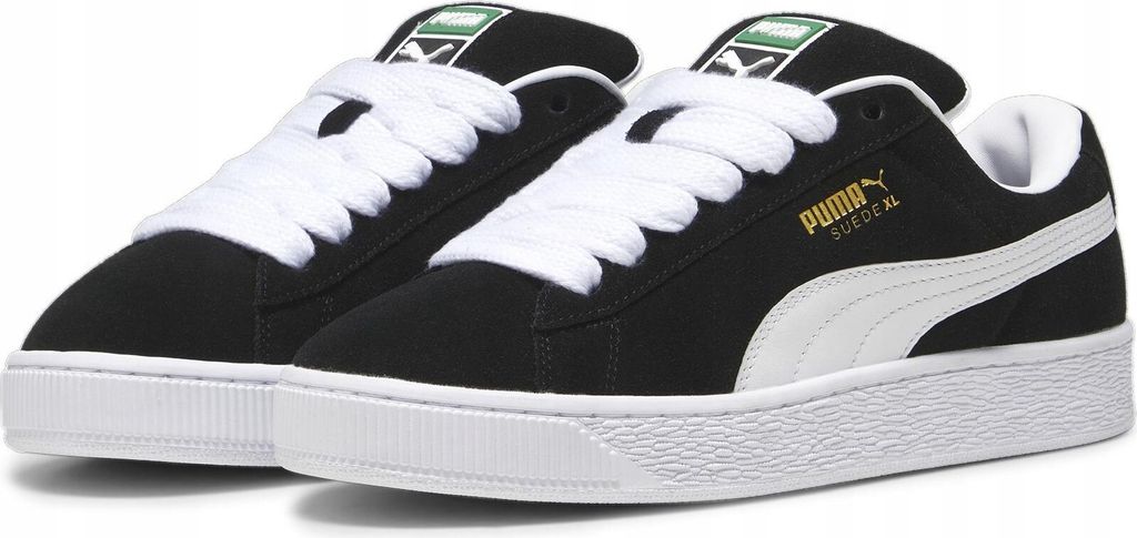 A pair of black Puma Suede XL sneakers with white laces and soles, shown from a side-angle.