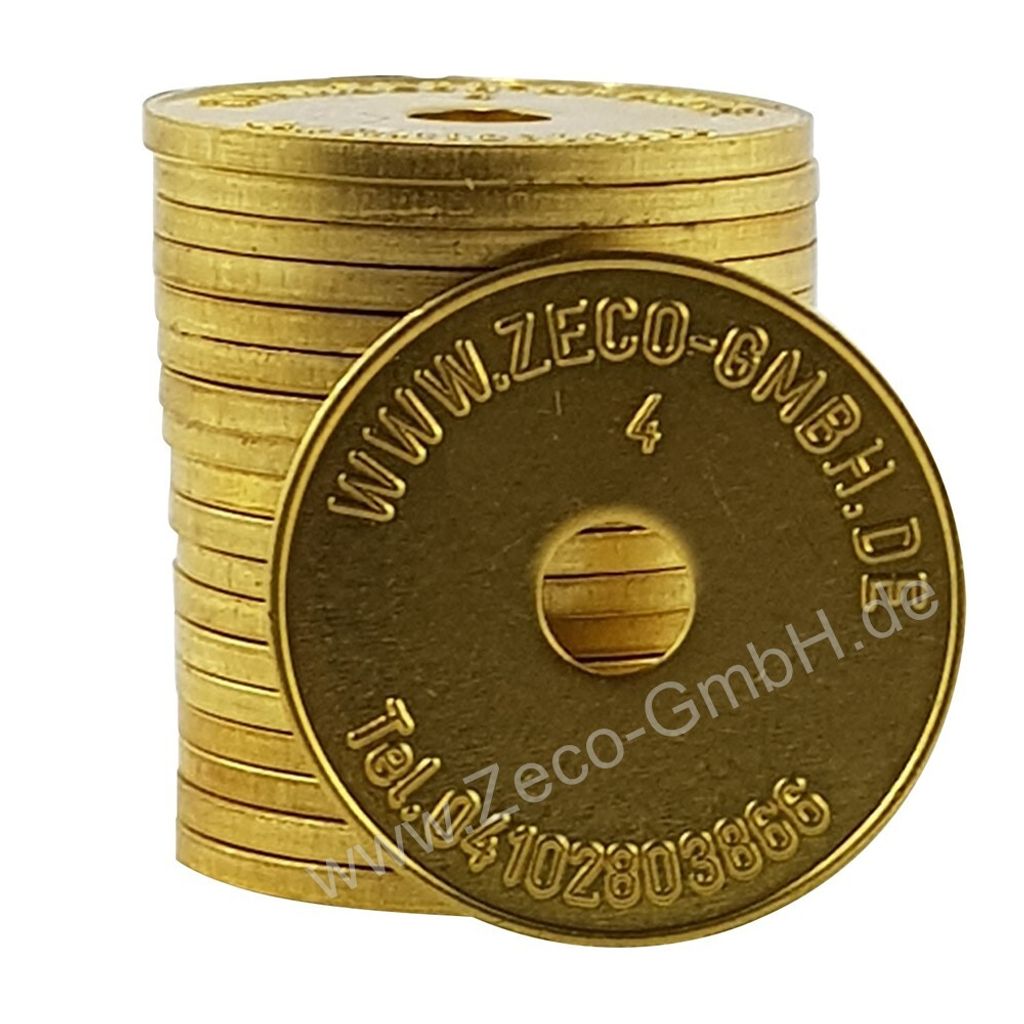 A stack of golden tokens with text and a hole in the center.