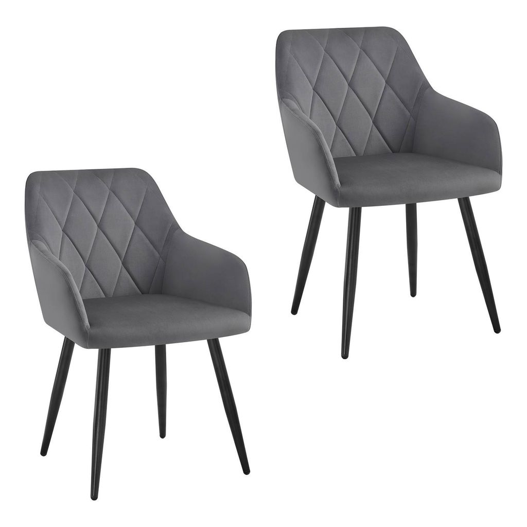 Two grey velvet dining chairs with diamond tufting and black metal legs against a white background.