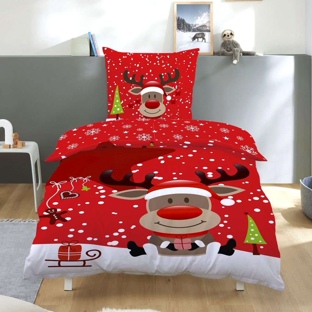 A Christmas-themed duvet cover set with a reindeer design is displayed on a bed.