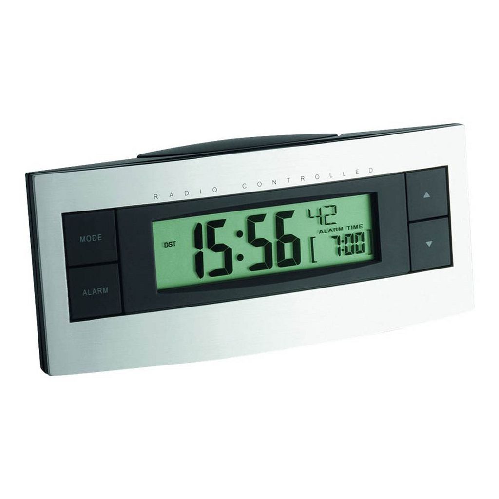 A digital alarm clock with a silver frame and a black face displaying the time and alarm settings.