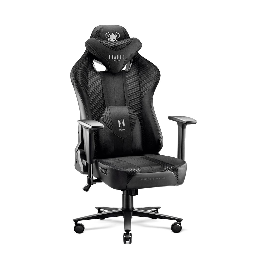 A black gaming chair with a skull logo on the headrest and lumbar pillow.