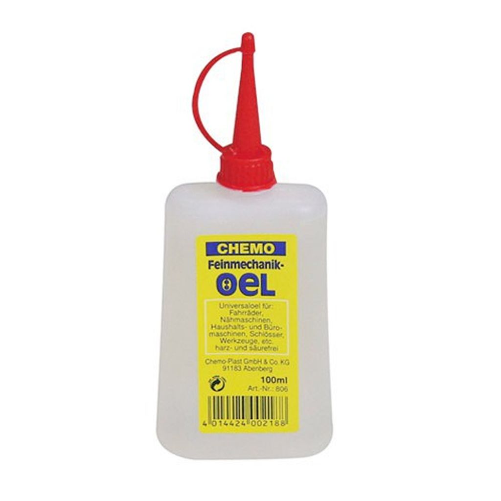 A white plastic bottle of oil with a red cap and spout, featuring a yellow label with product information.