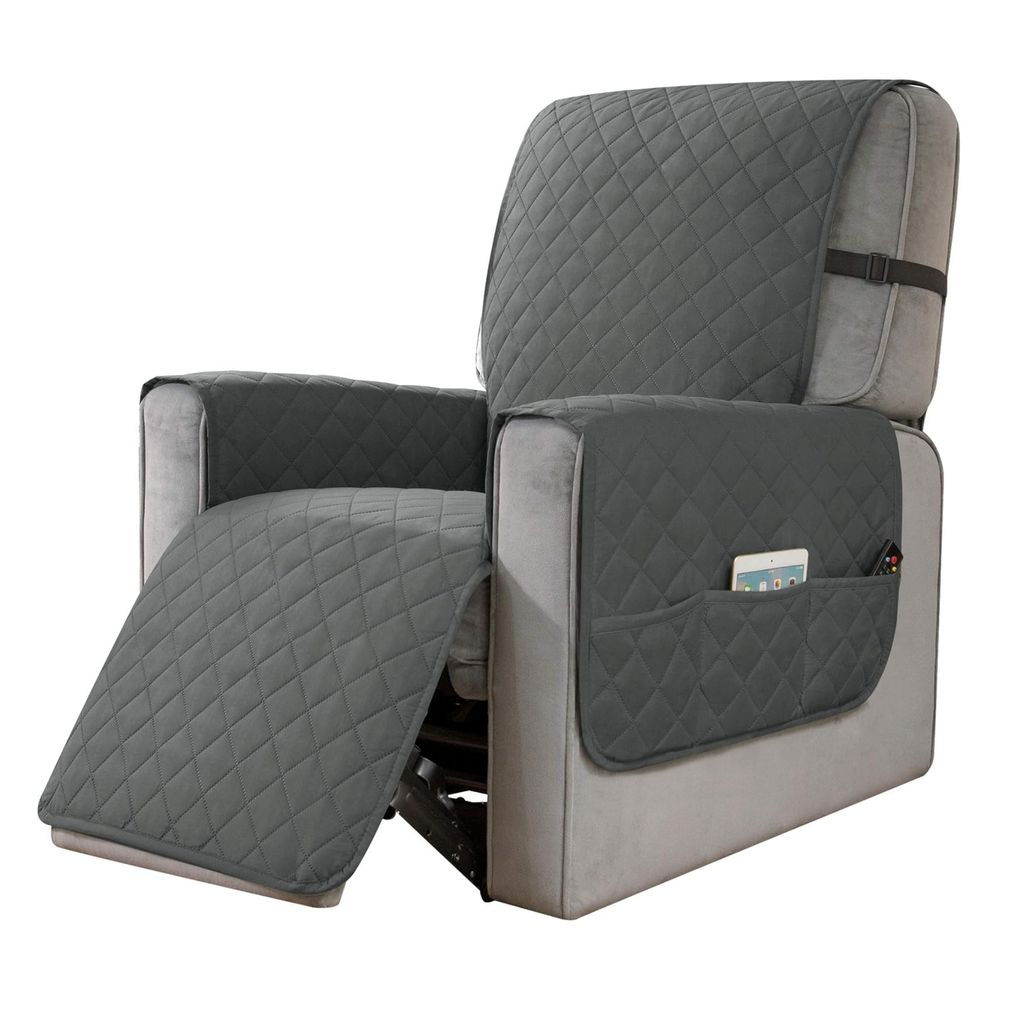 A gray recliner chair with a protective cover, showing the footrest extended and side pockets with a phone and remote.