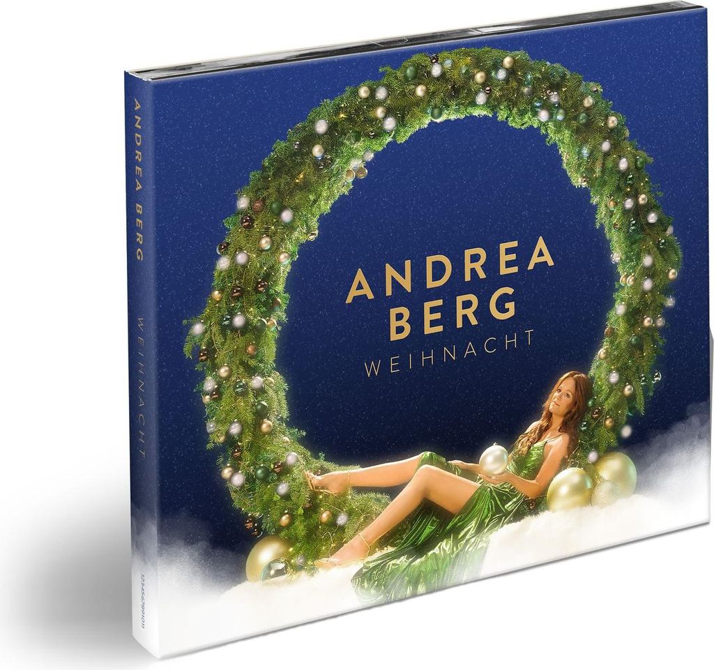 A product cover for a Christmas album by Andrea Berg, featuring a woman in a green dress lying on snow next to a Christmas wreath.