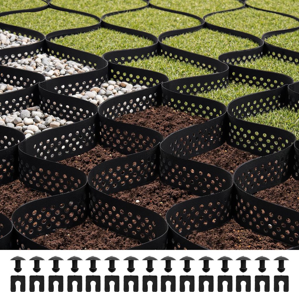 A close-up view of a black honeycomb grid system filled with gravel and soil, with green grass visible in the background. The grid is designed for ground stabilization.