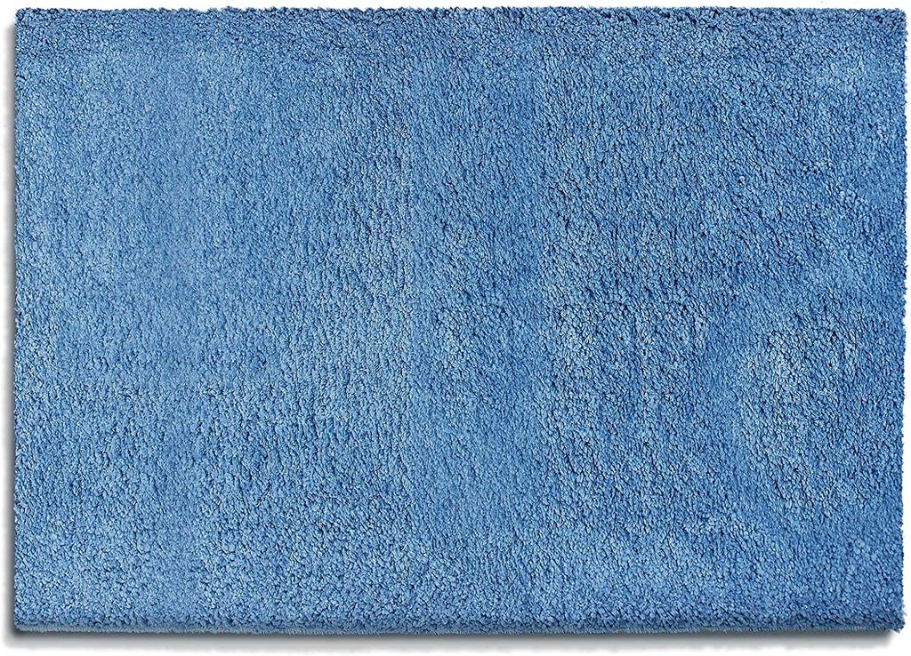 A close-up, top-down view of a light blue bath mat.