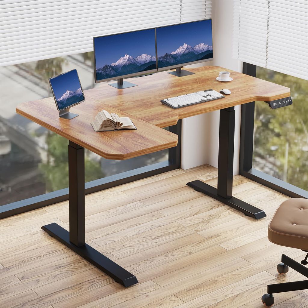 A modern adjustable height desk with dual monitors and a tablet, positioned next to a large window with blinds.