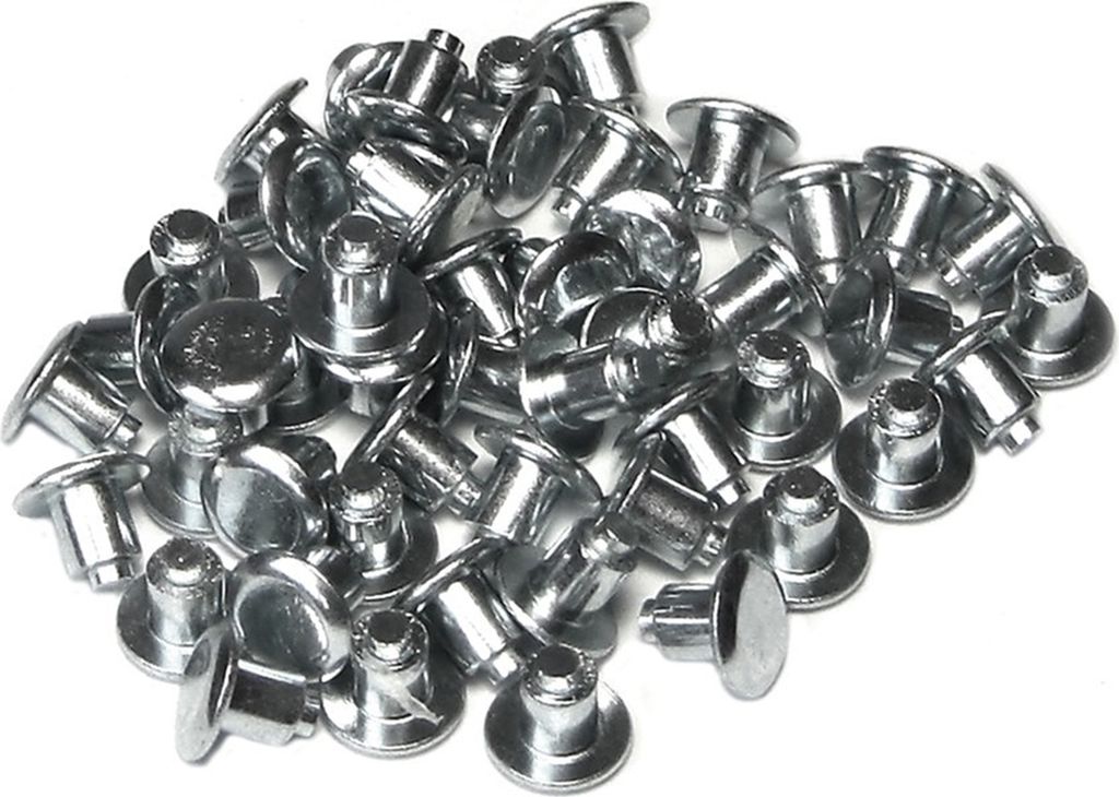 A pile of metal studs on a white background.