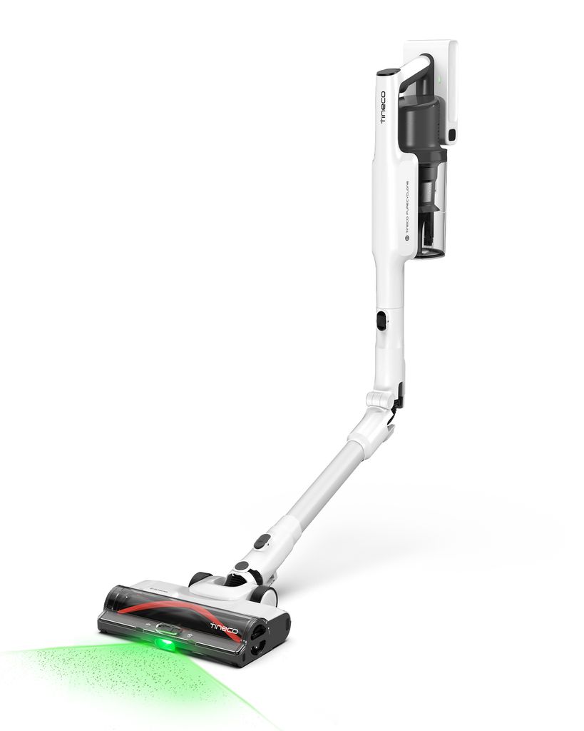 A white cordless vacuum cleaner is shown on a white background, with a green light emanating from the brush head.