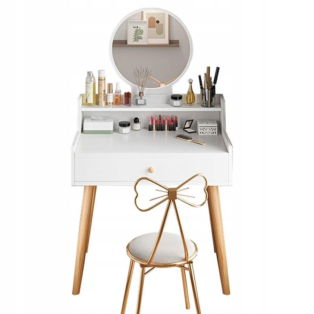 A white vanity table with a round mirror, makeup, and a golden chair with a bow back.