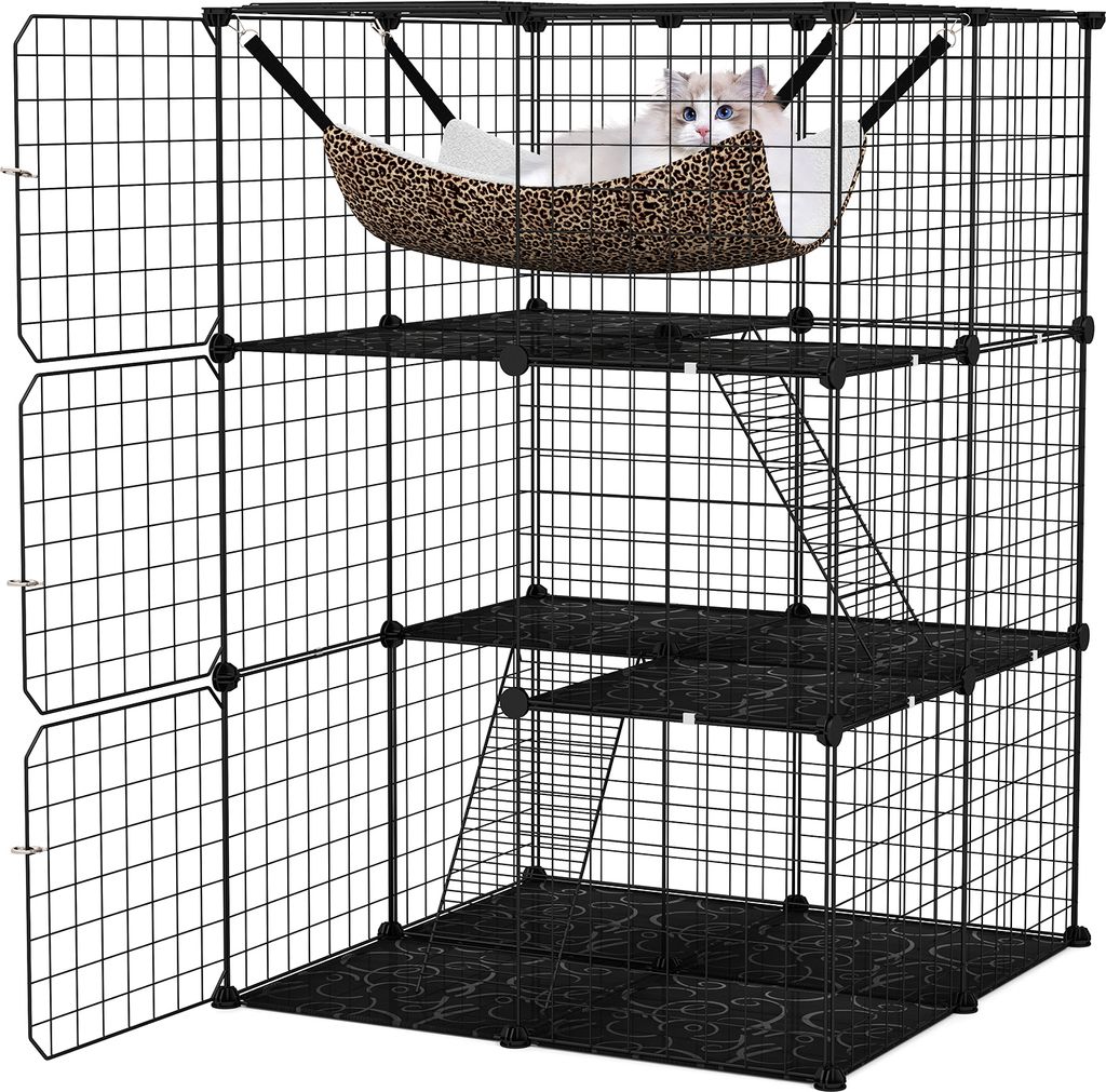 A multi-level cat cage with a cat in a hammock.