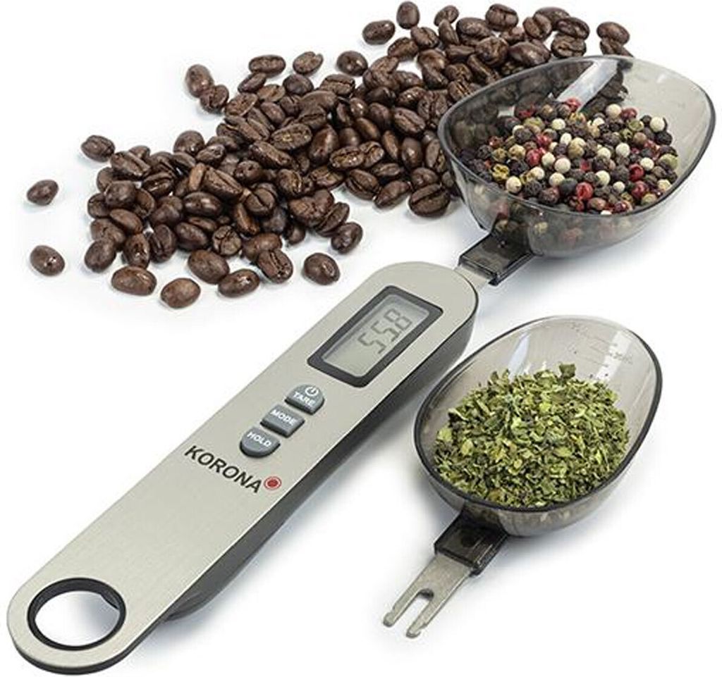 A digital spoon scale with coffee beans, peppercorns, and dried herbs.