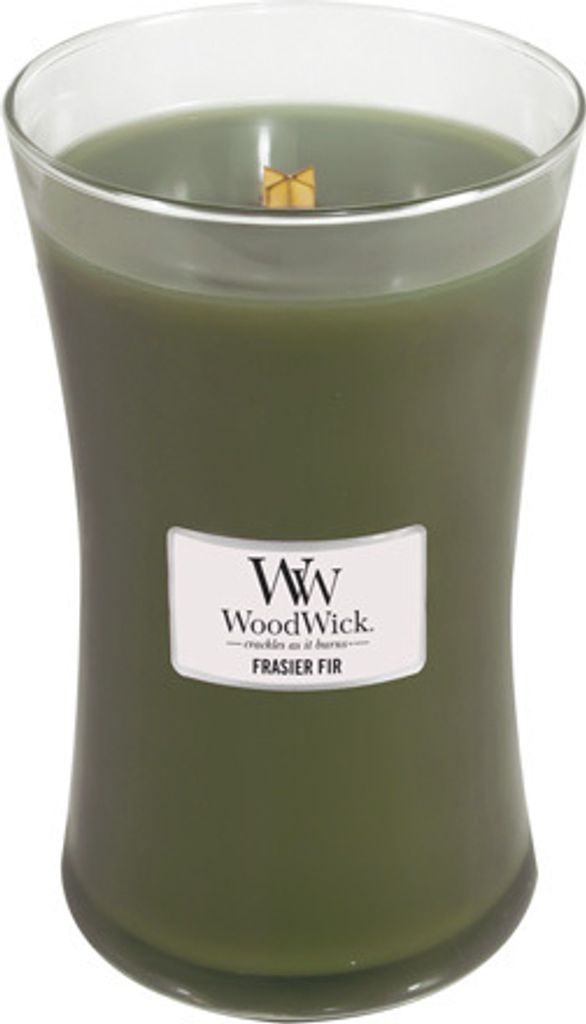 A green WoodWick candle in a clear glass jar with a wooden wick.