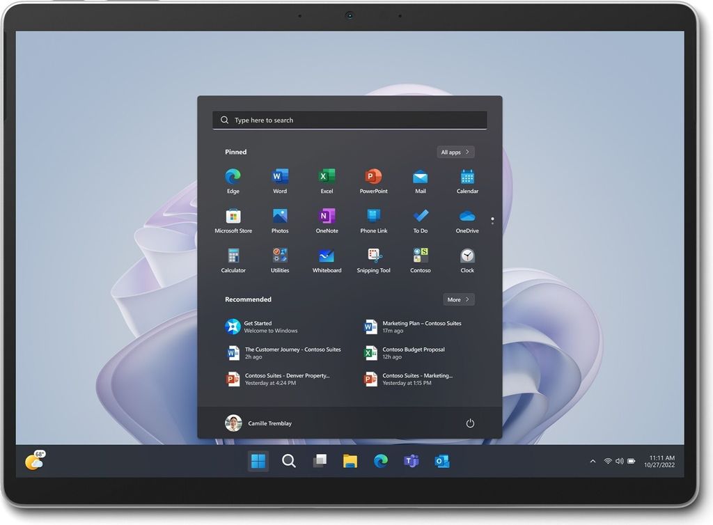 A Microsoft Surface Pro 9 for Business is shown on a desk with the Windows start menu open.