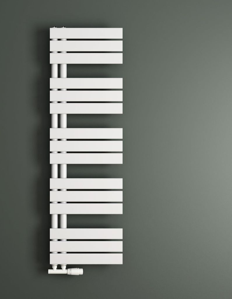 A white radiator is mounted on a gray wall.