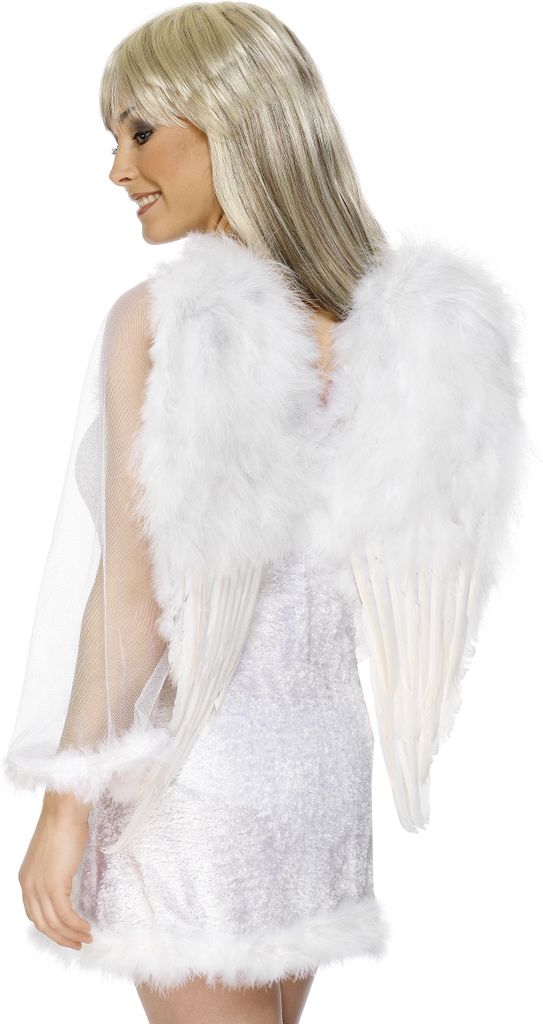 A woman wearing angel wings and a white dress.