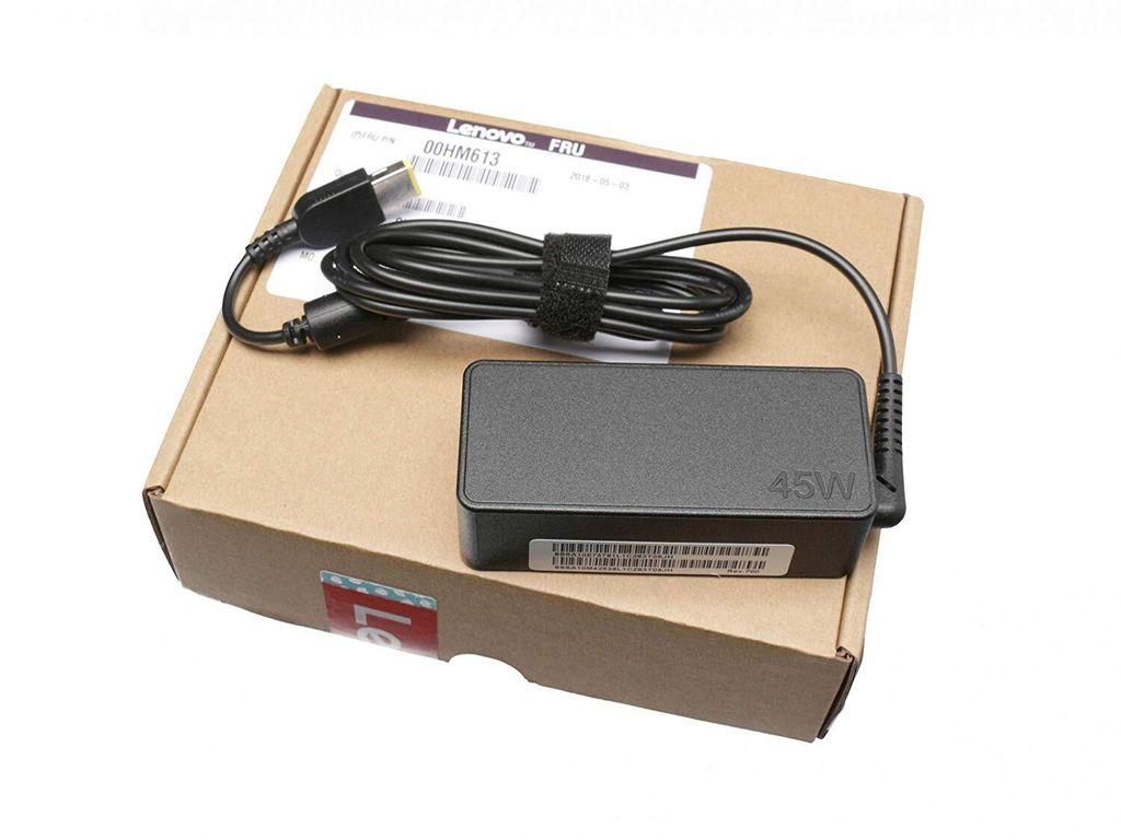 A Lenovo 45W slim tip laptop charger is placed on its cardboard packaging.