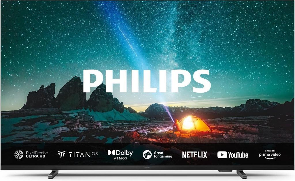 A Philips television displaying a scenic night sky with mountains and a tent.