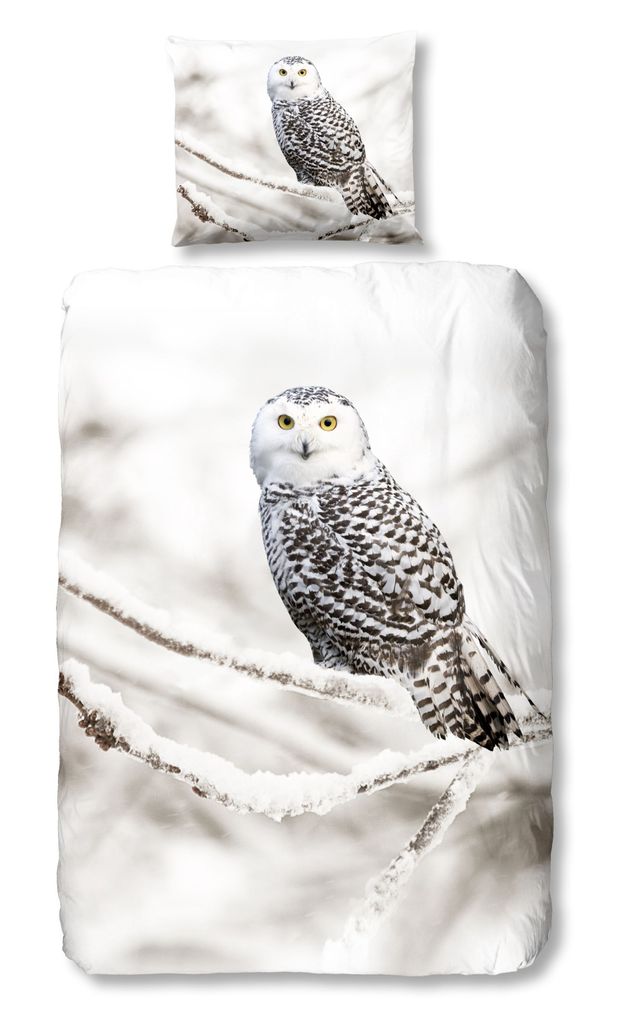 A duvet cover and pillowcase set featuring a snowy owl perched on a snow-covered branch.