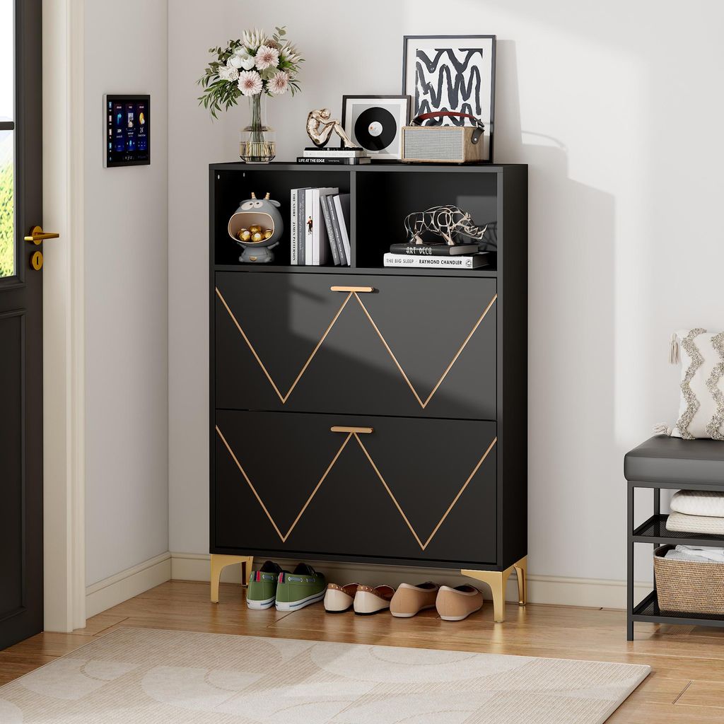 A black shoe cabinet with gold accents and metal legs, placed in a hallway next to a door and a bench.