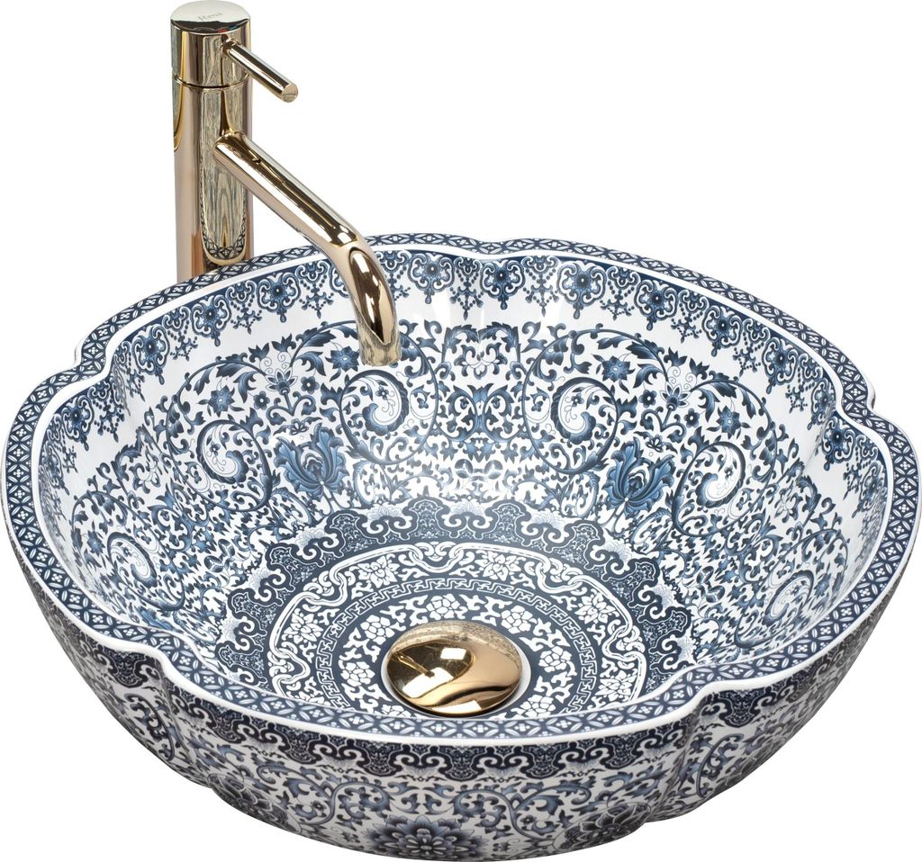 A decorative ceramic sink with a gold faucet.
