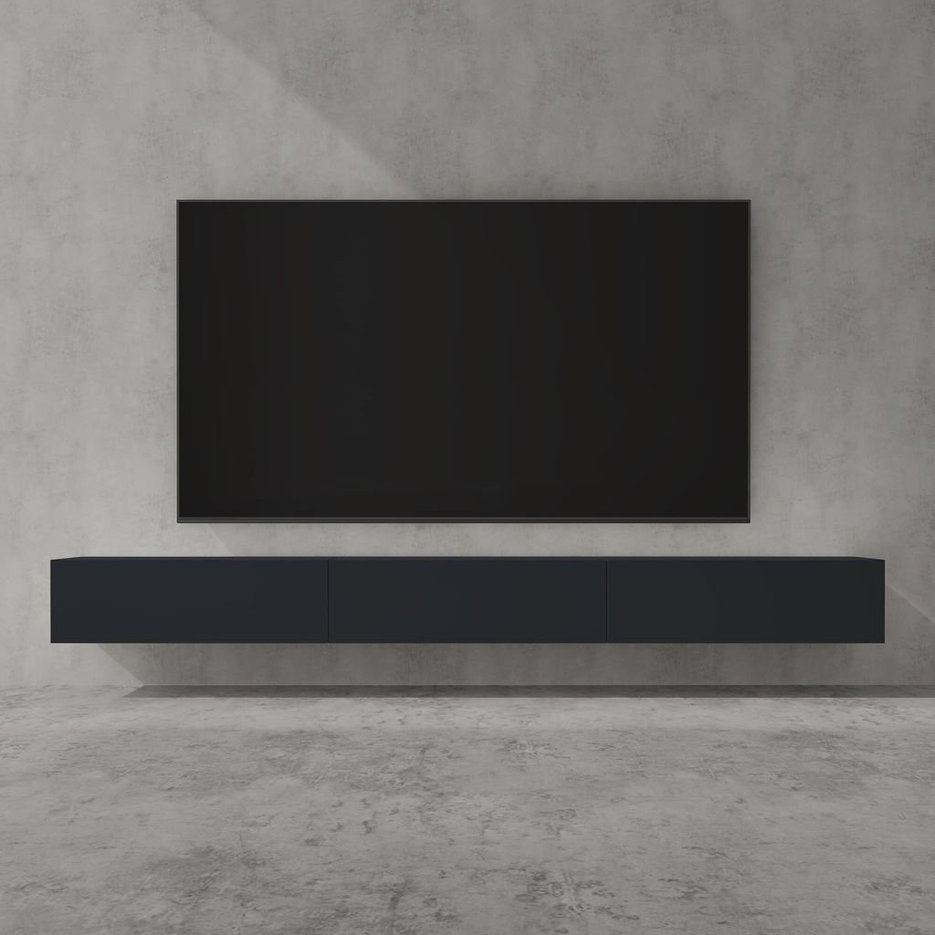 A modern, minimalist living room setup featuring a wall-mounted TV and a lowboard media console against a concrete wall.